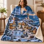 Snowy Lighthouse Village blanket, wrapped around a reader