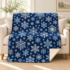 Navy Snowflakes blanket, on a sofa
