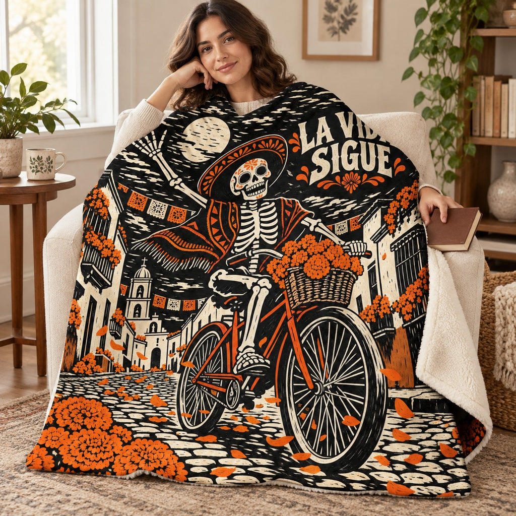 La Vida Sigue blanket, wrapped around a reader
