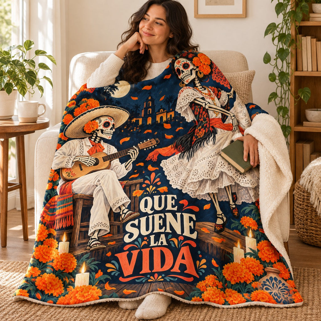Que Suene la Vida blanket, wrapped around a reader