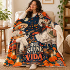 Que Suene la Vida blanket, wrapped around a reader
