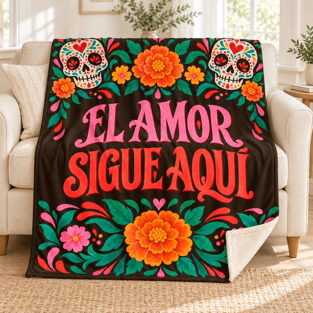 El Amor Sigue Aquí blanket, on a sofa