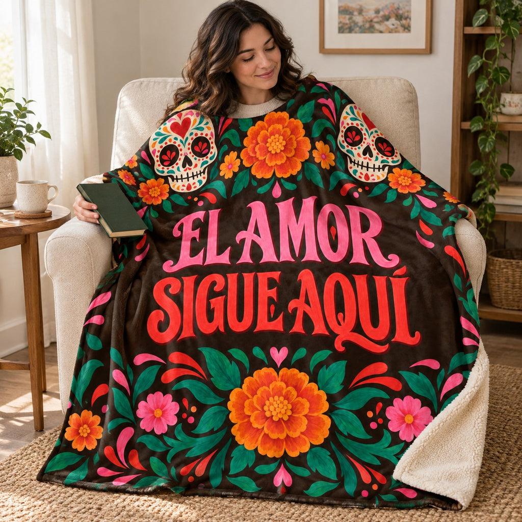 El Amor Sigue Aquí blanket, wrapped around a reader
