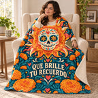Que Brille Tu Recuerdo blanket, wrapped around a reader