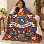 Siempre en mi corazon blanket, wrapped around a reader