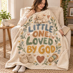 Little One, Loved by God blanket, wrapped around a reader