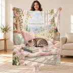 A Purrfect Reading Day blanket, held open